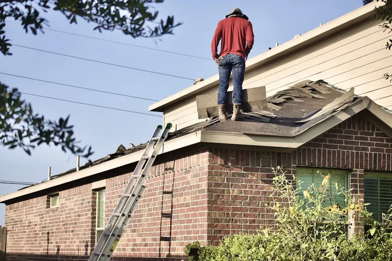 Professional roofer working on a residential roof in Schaumburg